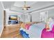 Bright main bedroom suite with hardwood floors, ceiling fan, and a doorway to the ensuite bathroom and walk-in closet at 3670 Cedar Springs Ln, Loganville, GA 30052