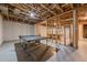 Unfinished basement space with a ping pong table and exposed ceiling, ready to be customized to your liking at 4732 Corina Ne Pl, Roswell, GA 30075