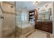 Elegant bathroom features a glass enclosed shower, soaking tub, custom vanity, and decorative lighting at 4732 Corina Ne Pl, Roswell, GA 30075