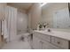 Bathroom features a shower/tub combo with a white vanity and a large mirror at 4732 Corina Ne Pl, Roswell, GA 30075