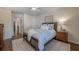 Bright bedroom with hardwood floors, ceiling fan, and a comfortable bed with decorative pillows at 4732 Corina Ne Pl, Roswell, GA 30075