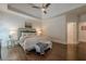 Cozy bedroom with dark hardwood floors, tray ceilings, and soft, neutral decor at 4732 Corina Ne Pl, Roswell, GA 30075