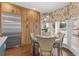 Eat-in breakfast nook with wood cabinets, stainless steel refrigerator, hardwood floors, and bay window with decorative shades at 4732 Corina Ne Pl, Roswell, GA 30075