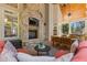 Covered stone patio with brick fireplace, TV, and outdoor dining set at 4732 Corina Ne Pl, Roswell, GA 30075