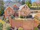 Beautiful brick home featuring manicured landscaping, a charming walkway, and arched windows offering an inviting curb appeal at 4732 Corina Ne Pl, Roswell, GA 30075