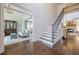 Bright foyer with staircase, hardwood floors, and an open view into the living room at 4732 Corina Ne Pl, Roswell, GA 30075