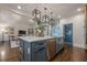 Open-concept kitchen with a large island, modern appliances, and hardwood flooring at 4732 Corina Ne Pl, Roswell, GA 30075