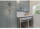 Well-equipped laundry room with modern washer and dryer, ample cabinet storage, and a bright window at 4732 Corina Ne Pl, Roswell, GA 30075