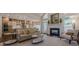 Open-concept living room and kitchen with hardwood floors and fireplace at 4732 Corina Ne Pl, Roswell, GA 30075