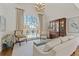 Elegant living room with large windows, stylish furnishings, and a decorative chandelier at 4732 Corina Ne Pl, Roswell, GA 30075