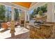 Outdoor kitchen and living area with stone pillars, granite countertops, stainless steel grill, and fireplace at 4732 Corina Ne Pl, Roswell, GA 30075