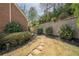 Manicured side yard with stone pathway and lush landscaping, perfect for enjoying the outdoors at 4732 Corina Ne Pl, Roswell, GA 30075
