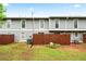 View of the building's backyard with a brown fence and green grass at 4974 Meadow Ln, Marietta, GA 30068