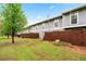 The building's backyard includes well-maintained lawns, a wooden fence, and mature trees at 4974 Meadow Ln, Marietta, GA 30068