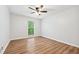 Bright bedroom featuring hardwood floors, a window and ceiling fan at 4974 Meadow Ln, Marietta, GA 30068