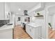 Modern kitchen features white cabinets, stainless hood, quartz counters, and black subway tile backsplash at 4974 Meadow Ln, Marietta, GA 30068
