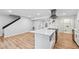 Open kitchen with island, stainless appliances, hardwood floors, and modern design at 4974 Meadow Ln, Marietta, GA 30068