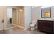 Bathroom featuring a vanity with drawers, tiled floor, toilet, and glass-enclosed shower at 6227 Braidwood Nw Way, Acworth, GA 30101