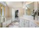 Bathroom features double sinks, walk-in closet, tub, and tiled floors at 6227 Braidwood Nw Way, Acworth, GA 30101