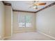 Bedroom with carpet, fan, and views outside at 6227 Braidwood Nw Way, Acworth, GA 30101