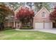 Charming two-story brick home with a well-manicured lawn, mature trees, and a two-car garage at 6227 Braidwood Nw Way, Acworth, GA 30101