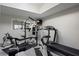 A home gym with complete workout station, treadmill, bike, weight lifting station, and wall-mounted TV at 6227 Braidwood Nw Way, Acworth, GA 30101