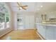 Inviting kitchen area with a breakfast bar, white cabinets, and views of the wooded backyard at 6227 Braidwood Nw Way, Acworth, GA 30101