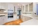 Well-lit kitchen with hardwood floors, white cabinets, a gas cooktop, and stainless steel appliances at 6227 Braidwood Nw Way, Acworth, GA 30101