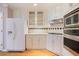 Well-lit kitchen with hardwood floors, white cabinets, a gas cooktop, and stainless steel appliances at 6227 Braidwood Nw Way, Acworth, GA 30101