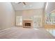 Spacious living room with a brick fireplace, vaulted ceiling, large windows, and neutral carpet at 6227 Braidwood Nw Way, Acworth, GA 30101