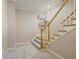 Carpeted staircase with wooden handrail and pink walls at 6227 Braidwood Nw Way, Acworth, GA 30101