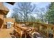 Outdoor wooden deck has a grill and dining table with views of the surrounding greenery at 1087 High Point Ne Dr, Atlanta, GA 30306