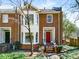 Charming brick townhome featuring a red front door, bay window and inviting curb appeal at 1087 High Point Ne Dr, Atlanta, GA 30306