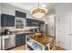 Charming kitchen features blue cabinets, stainless steel appliances, and a stylish mobile island at 1087 High Point Ne Dr, Atlanta, GA 30306