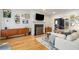 Bright living room with fireplace, wood floors, and stylish decor creates a warm and inviting atmosphere at 1087 High Point Ne Dr, Atlanta, GA 30306