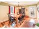 Open dining area featuring hardwood floors, natural lighting, modern light fixture, and access to outdoor space at 165 Carriage Gate Dr, Sharpsburg, GA 30277