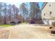 Spacious driveway and detached garage with a lush tree line in the background at 165 Carriage Gate Dr, Sharpsburg, GA 30277