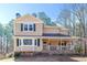 Charming two-story home with a welcoming front porch and a well-maintained yard, perfect for outdoor enjoyment at 165 Carriage Gate Dr, Sharpsburg, GA 30277