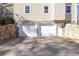 Attached two car garage with stone accent walls and level driveway at 165 Carriage Gate Dr, Sharpsburg, GA 30277