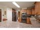 Spacious kitchen with stainless steel appliances, wooden cabinetry, and granite countertops at 165 Carriage Gate Dr, Sharpsburg, GA 30277