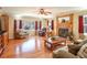 Spacious living room with hardwood floors, fireplace, large bay window, and comfortable seating area at 165 Carriage Gate Dr, Sharpsburg, GA 30277