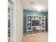 Living room with a media center against a blue accent wall, and a mirror door showing another room at 165 Carriage Gate Dr, Sharpsburg, GA 30277
