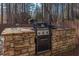 Outdoor stone grill setup with a sink and grill for outdoor cooking at 165 Carriage Gate Dr, Sharpsburg, GA 30277