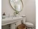 Bathroom featuring pedestal sink, oval mirror, and crisp white walls at 249 The South Chace Ne, Atlanta, GA 30328