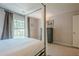Carpeted bedroom featuring large windows and a chest of drawers with neutral decor at 249 The South Chace Ne, Atlanta, GA 30328