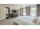 Airy bedroom with a large dresser, mirror, and natural light streaming through the windows at 249 The South Chace Ne, Atlanta, GA 30328