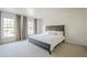 Bright bedroom with large windows, neutral carpet, and a modern platform bed at 249 The South Chace Ne, Atlanta, GA 30328