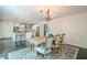 Elegant dining area with chandelier next to a beautifully designed open concept kitchen at 249 The South Chace Ne, Atlanta, GA 30328