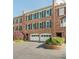 Classic brick townhome with two-car garage, green shutters, and landscaped front yard at 249 The South Chace Ne, Atlanta, GA 30328