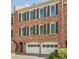 Charming brick townhome with two-car garage, green shutters, and manicured landscaping at 249 The South Chace Ne, Atlanta, GA 30328